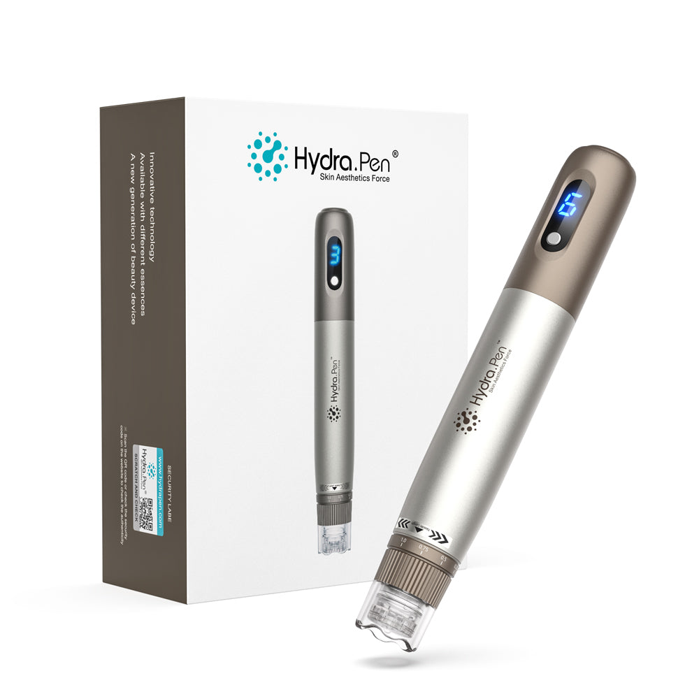 Hydra Pen H3-Handstück aus Silber und Bronze neben der Originalverpackung